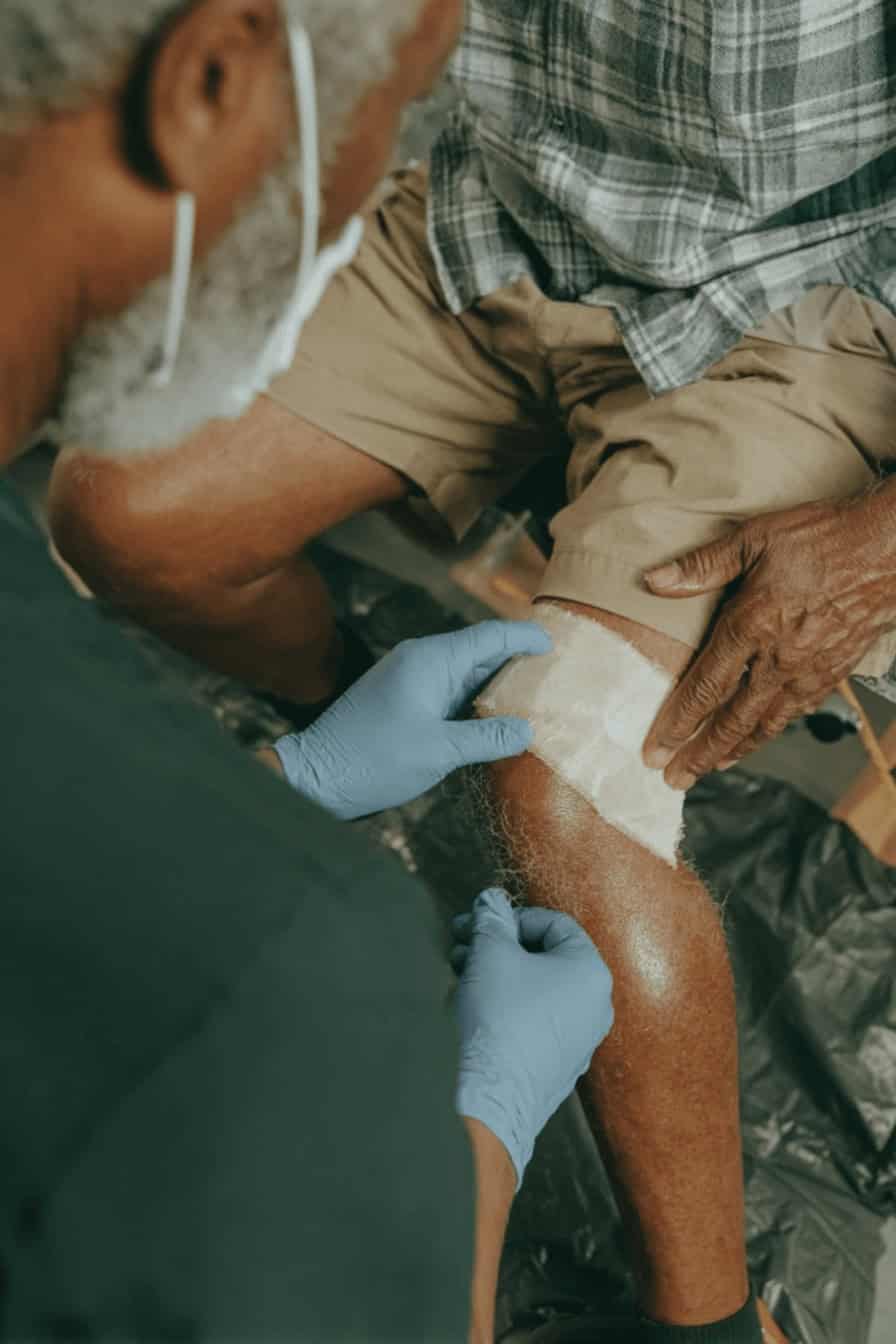 Advanced wound care specialist treating chronic leg wound at home